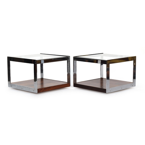 695 - A pair of Merrow Associates rosewood and chrome plated two tier coffee tables, each with glass inset... 