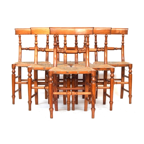 654 - A set of six 19th century satin-birch dining chairs, the curved rail over a faceted turned mid-rail,... 