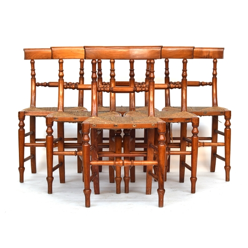 654 - A set of six 19th century satin-birch dining chairs, the curved rail over a faceted turned mid-rail,... 