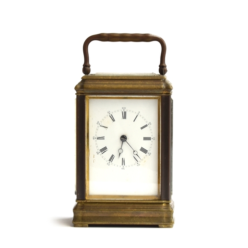 572 - A gilt metal carriage clock with bevelled glass panels and enamel dial with Roman numerals, 16.5cm h... 