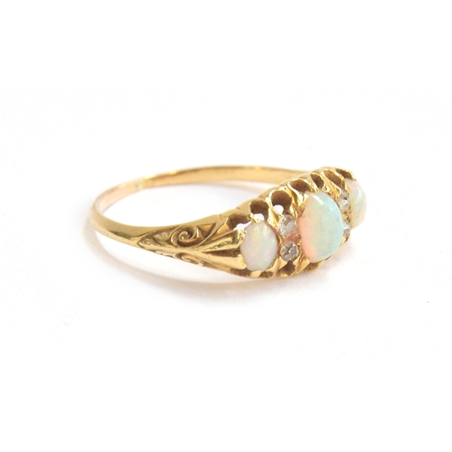 10 - A gold ring set with three opals and diamonds, tests as 22ct, size N 1/2, approx. 2.5g