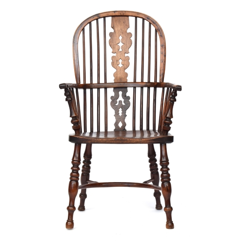 671 - A yew and elm splat back Windsor chair, probably Lincolnshire, turned front arm supports, the saddle... 