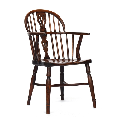 674 - A yew and elm Windsor chair, pierced splat, the elm saddle seat raised on baluster turned legs joine... 