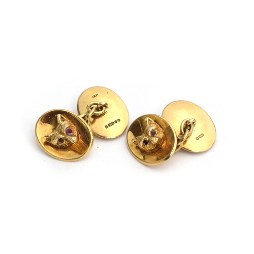 63 - A pair of 9ct gold fox mask cufflinks, each set with ruby eyes, approx. 18.4g