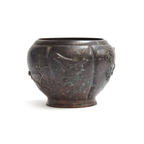 257 - A Japanese Meiji era bronze jardiniere of lobed tapering form, decorated with birds and prunus, 18.5... 