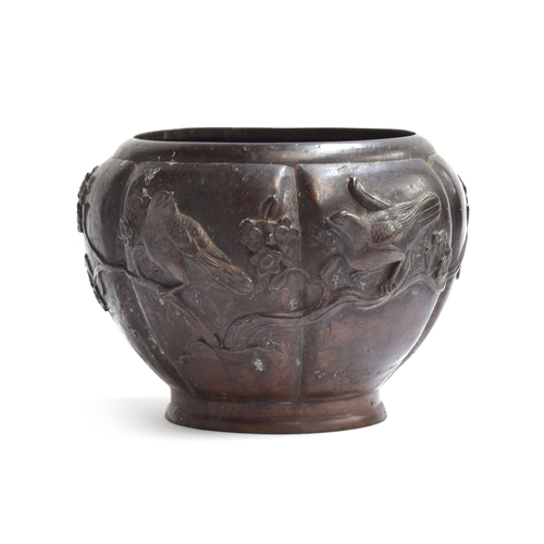 257 - A Japanese Meiji era bronze jardiniere of lobed tapering form, decorated with birds and prunus, 18.5... 