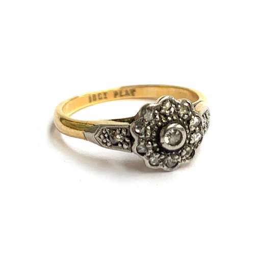 5 - An 18ct gold and platinum ring set with diamond chips in a floral cluster, approx. 2.8g, size K