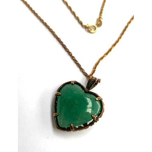 7 - A 9ct gold pendant in the form of an agate heart mounted in a floral cage, on a 9ct gold chain, appr... 