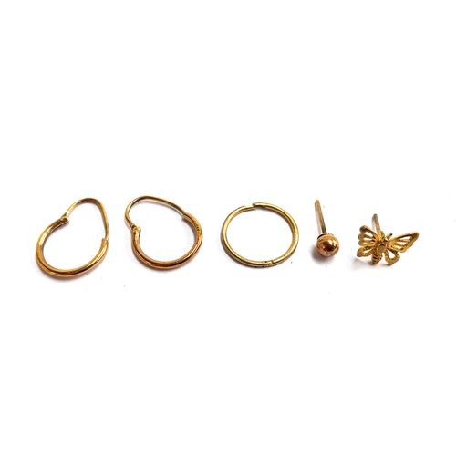 13 - 9ct gold hoop earrings, approx. 1g; together with three unmatched gold earrings, approx. 1.3g