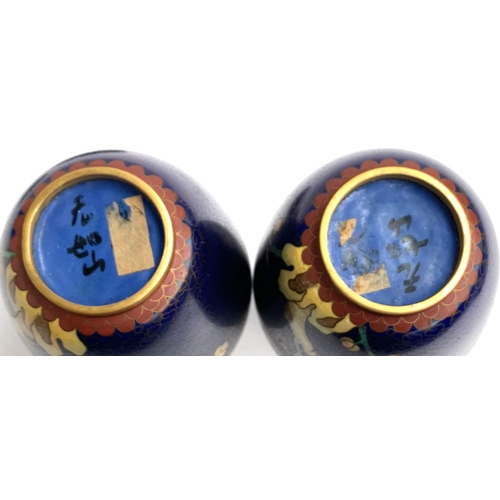 141 - A pair of cloisonne enamel vases, character marks to base, each on carved stands, 19.5cmH with stand