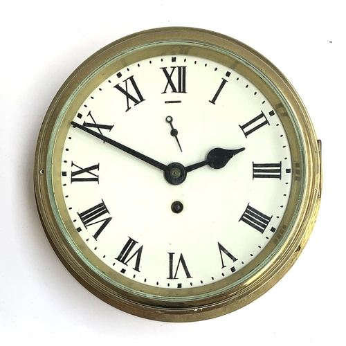 57 - A copper and brass ship's clock, white enamel dial with Roman numerals, the dial 18cmD