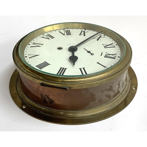 57 - A copper and brass ship's clock, white enamel dial with Roman numerals, the dial 18cmD