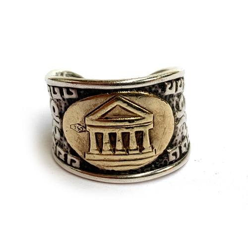 17 - An Italian 925 silver ring with embossed Greek key pattern, with an applied 18ct gold panel depictin... 