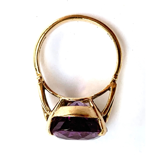 30 - A 9ct gold ring set with a large oval amethyst, the stone 2cm long, size T 1/2, 8.3g