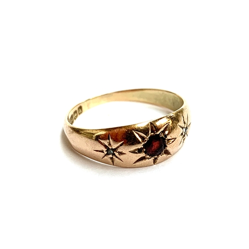 33 - A 9ct gold gypsy ring set with diamond chips and a garnet, size P, 2.4g