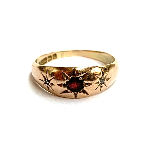 33 - A 9ct gold gypsy ring set with diamond chips and a garnet, size P, 2.4g