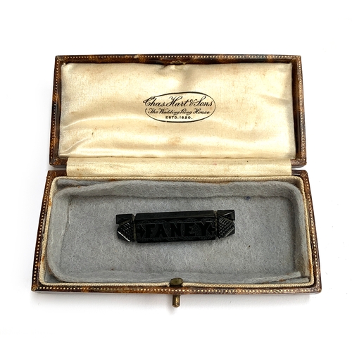 1 - A 19th century carved jet mourning brooch reading 'Faney', 4.5cmL, in a brown leather box