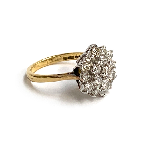 45 - An 18ct gold and diamond cluster ring, set with 19 brilliant cut diamonds, the central diamond appro... 