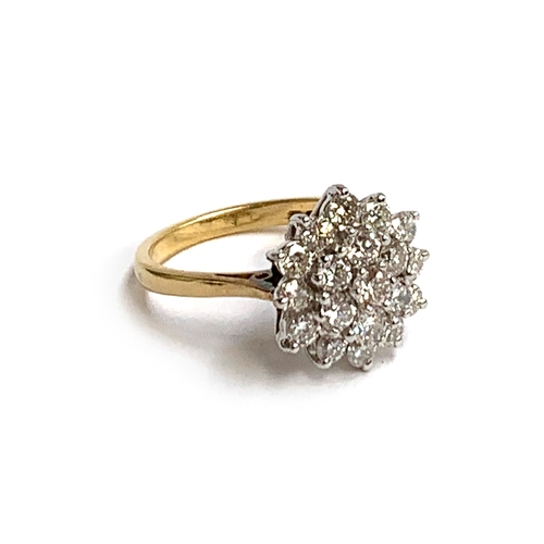 45 - An 18ct gold and diamond cluster ring, set with 19 brilliant cut diamonds, the central diamond appro... 