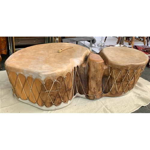 713 - A double trunk cottonwood drum, covered in buffalo hide, purchase in Taos, New Mexico, approximately... 