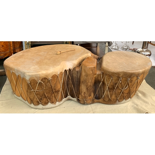 713 - A double trunk cottonwood drum, covered in buffalo hide, purchase in Taos, New Mexico, approximately... 