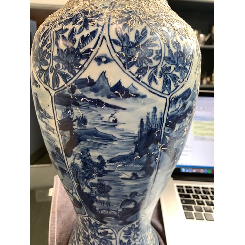 262 - A large Chinese blue and white urn, recovered from a shipwreck, with panels depicting flora and land... 