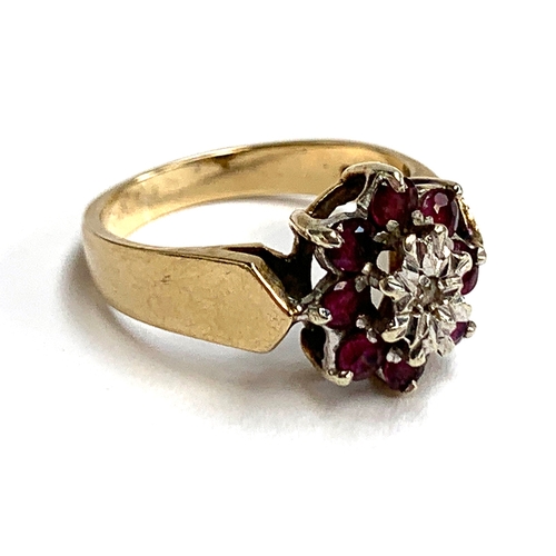 31 - A 9ct gold floral cluster ring set with rubies and an illusion set diamond, size N 1/2, approx. 3.9g