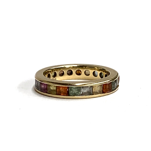 52 - A 9ct gold and channel set multi-coloured topaz eternity ring, size N, approx. 4.2g