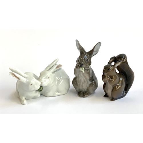 157 - Three Royal Copenhagen figurines, pair of rabbits no. 518, rabbit eating no. 1019 and squirrel no. 9... 