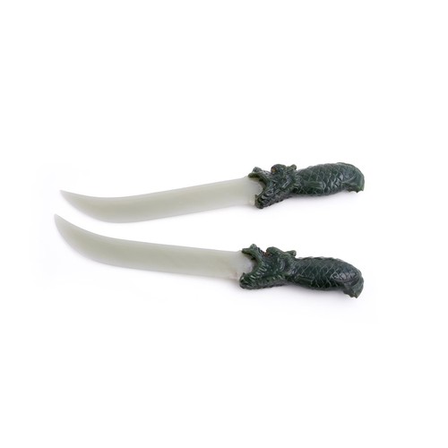 318 - A pair of jadeite models of daggers, 20th century, the spinach green handles carved as dragons with ... 