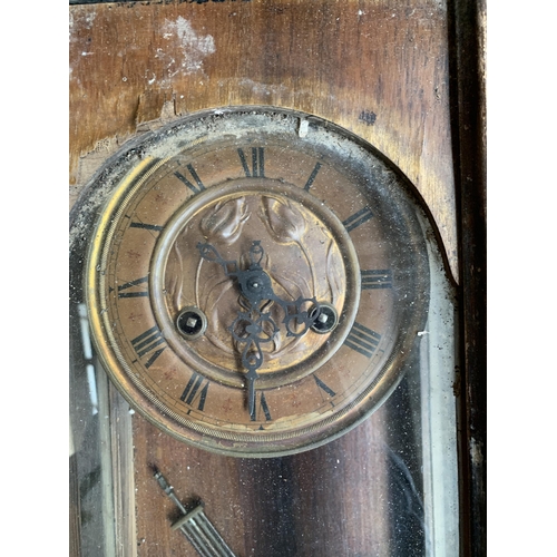 39 - A cased wall clock, 69cmH