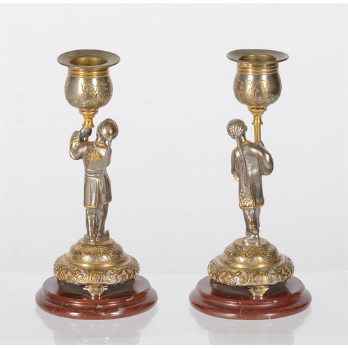 325 - A pair of 20th century French parcel gilt and silvered figural candlesticks, each modelled as a figu... 