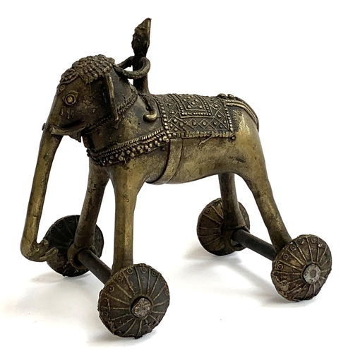 373 - An Indian bronze temple toy in the form of an elephant and rider, raised on four wheels, 19cmH