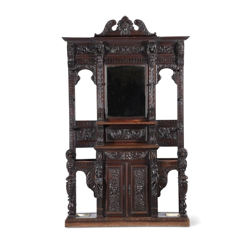 923 - A carved oak hall stand in antiquarian taste late 19th or early 20th century with ivorine label to t... 