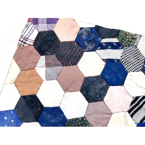 434 - A small antique hexagonal silk quiltwork (af), 39x52.5cm