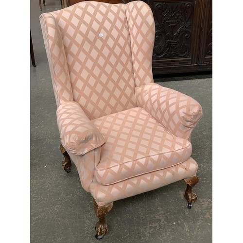 931 - A wingback armchair on claw and ball feet, 77cmW