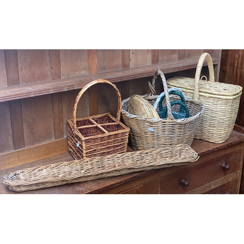 921 - A quantity of baskets to include a wicker four bottle wine holder