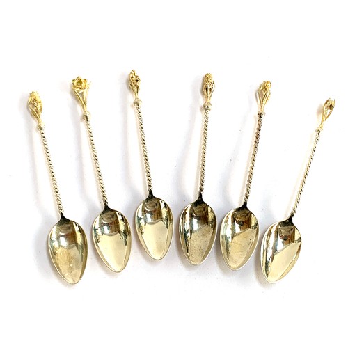 57 - A set of six .925 silver teaspoons, each with silver gilt floral terminal