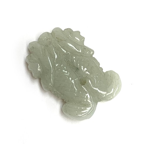 251 - A Chinese carved celadon jade pendant in the form of two fish, 3.3cmL