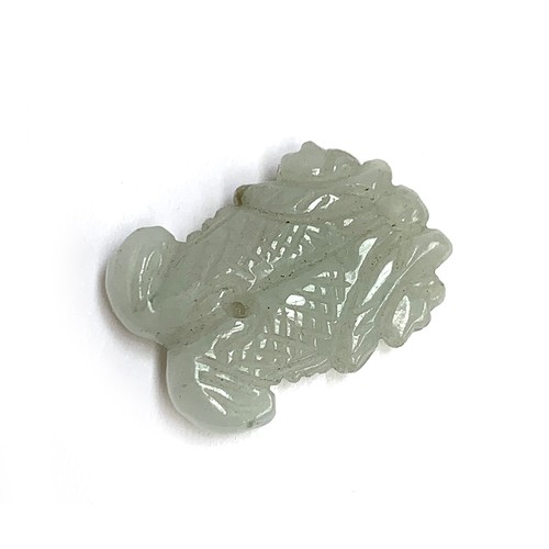 251 - A Chinese carved celadon jade pendant in the form of two fish, 3.3cmL