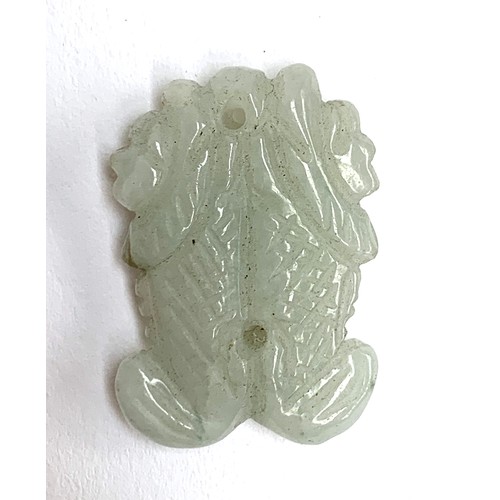 251 - A Chinese carved celadon jade pendant in the form of two fish, 3.3cmL