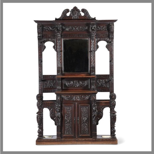 923 - A carved oak hall stand in antiquarian taste late 19th or early 20th century with ivorine label to t... 