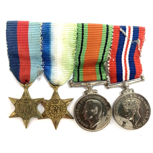 660 - A collection of four miniature medals to include World War II service medal, The Defence Medal, Atla... 