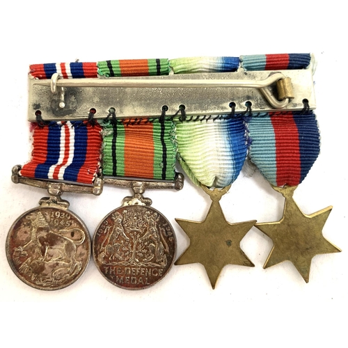 660 - A collection of four miniature medals to include World War II service medal, The Defence Medal, Atla... 