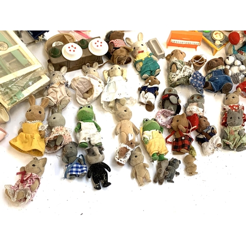 1196 - A quantity of toys, figures and dolls to include Sylvanian families, Polly Pocket etc