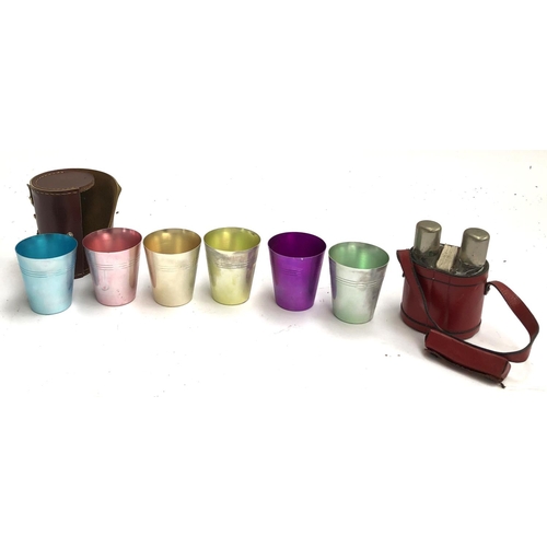 96 - A set of 6 coloured metal stirrup cups, leather cased, together with 2 flasks, cards and dice in a r... 