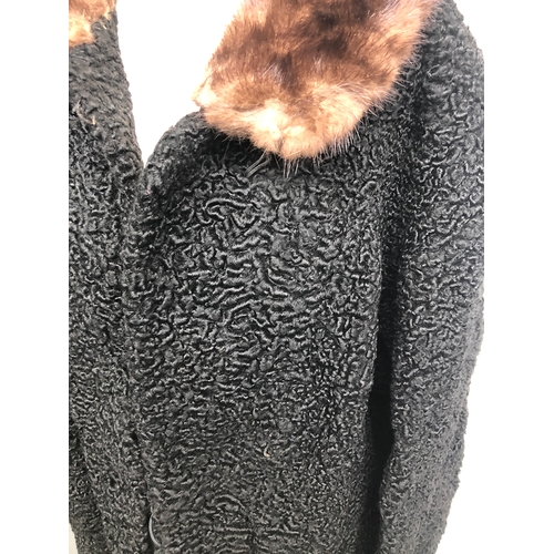 751 - A ladies black astrakan coat, with fur collar