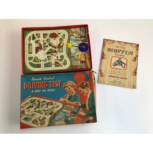 1321 - A Merit Toys remote control driving test game, together with The First Muffin Songbook