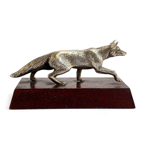 164 - A white metal figure of a prowling fox, approx. 15cm long