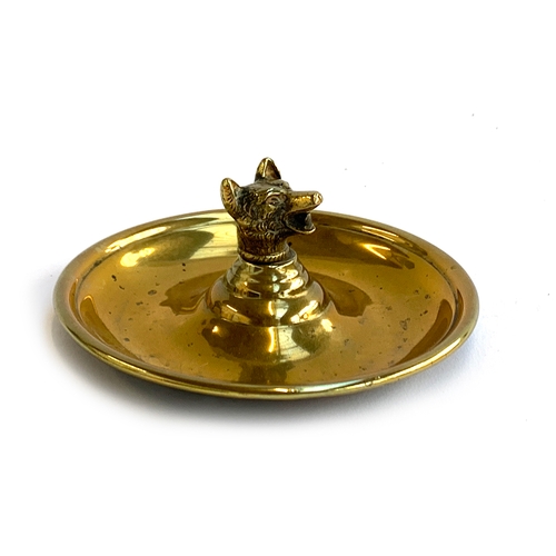 165 - A brass ashtray, centred with a cast fox mask, 12.5cm diameter